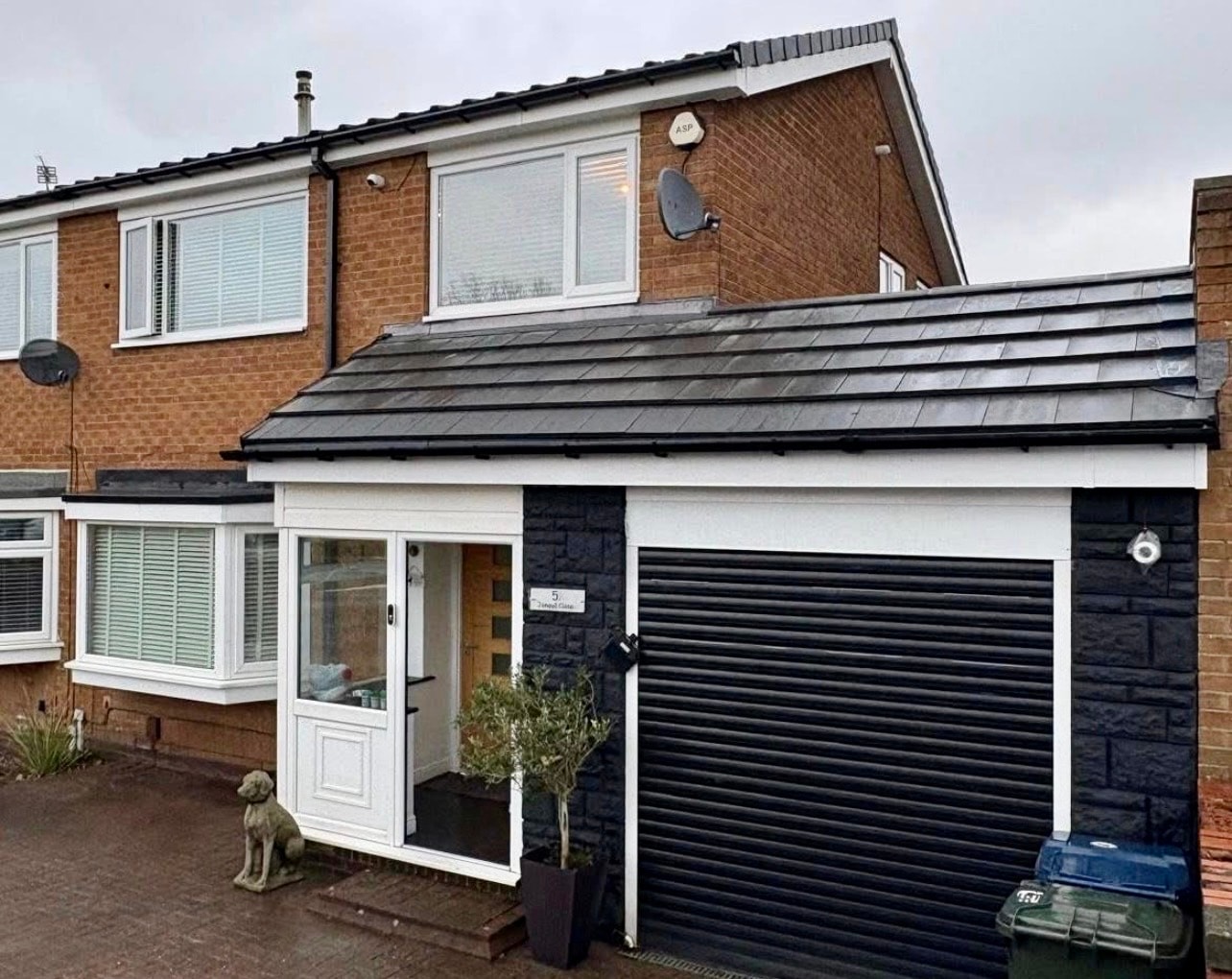 After-Front roof structure completed with a professionally installed new roof.
